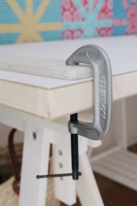 The Machine Quilter frame clamped to the table